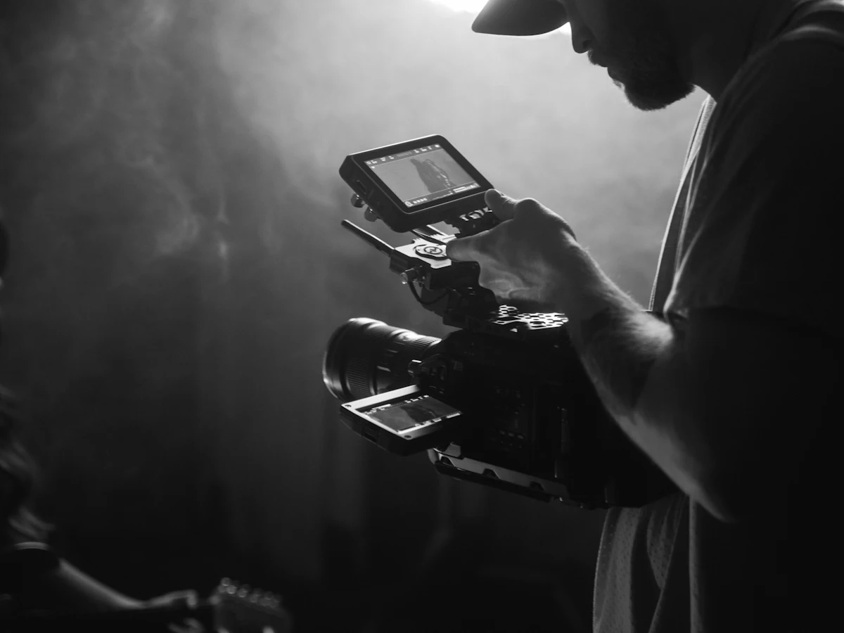 A videographer filming with a handheld camera