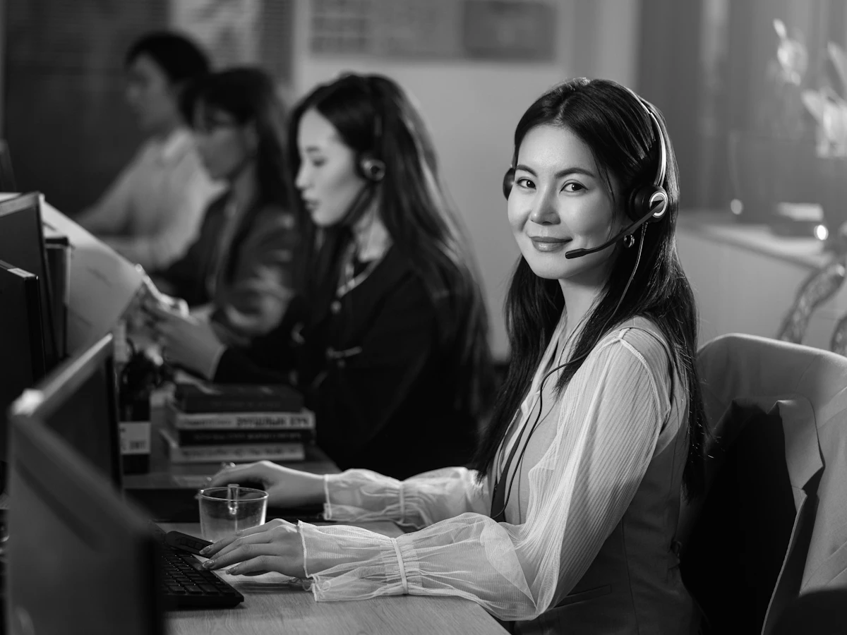 A support agent wearing a headset at her desk
